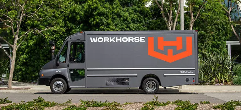 Workhorse W56 EV step van on a residential street with green trees