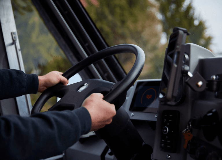 Driver'S Hands On The Steering Wheel Of A W56 Electric Delivery Step Van